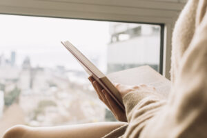 Unrecognizable Lady Reading Near Window